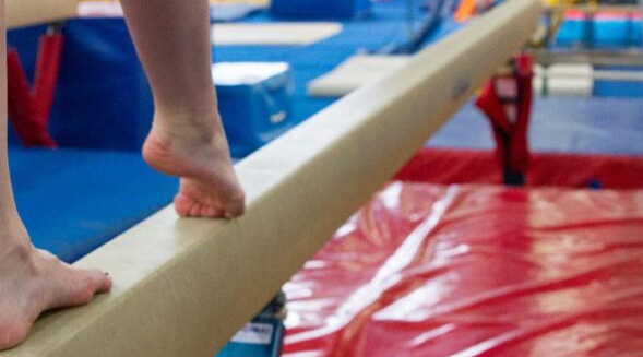 Pies sobre una barra de equilibrio